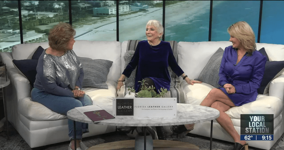 ABC's Linda Carson and Stephanie Roberts sitting on a couch with singer, Judy Collins.